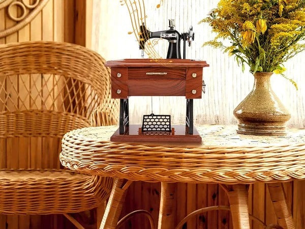 Sewing machine music box on a wicker table
