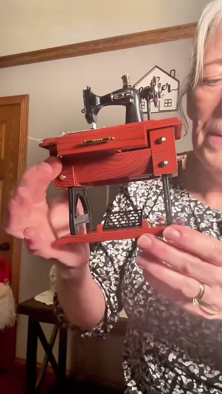 Grandmother holding the sewing machine music box