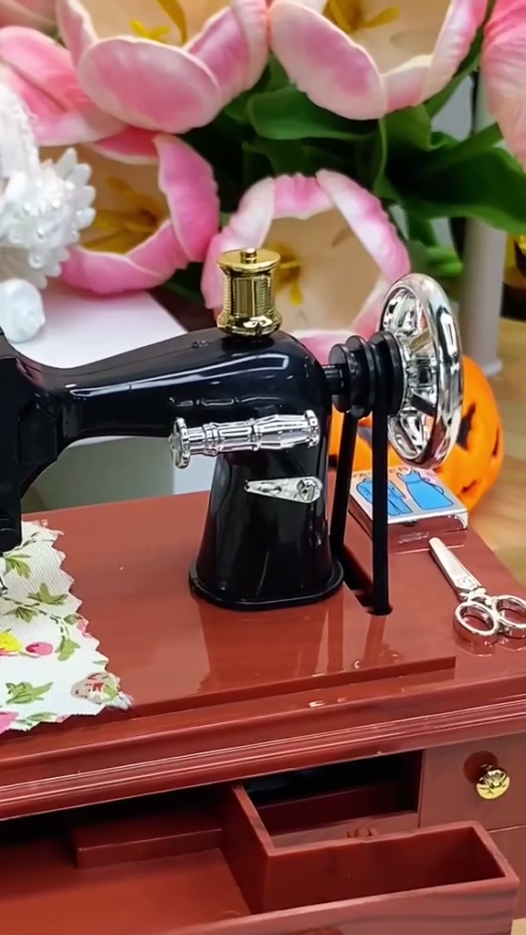 Close-up of the miniature machine with flowers