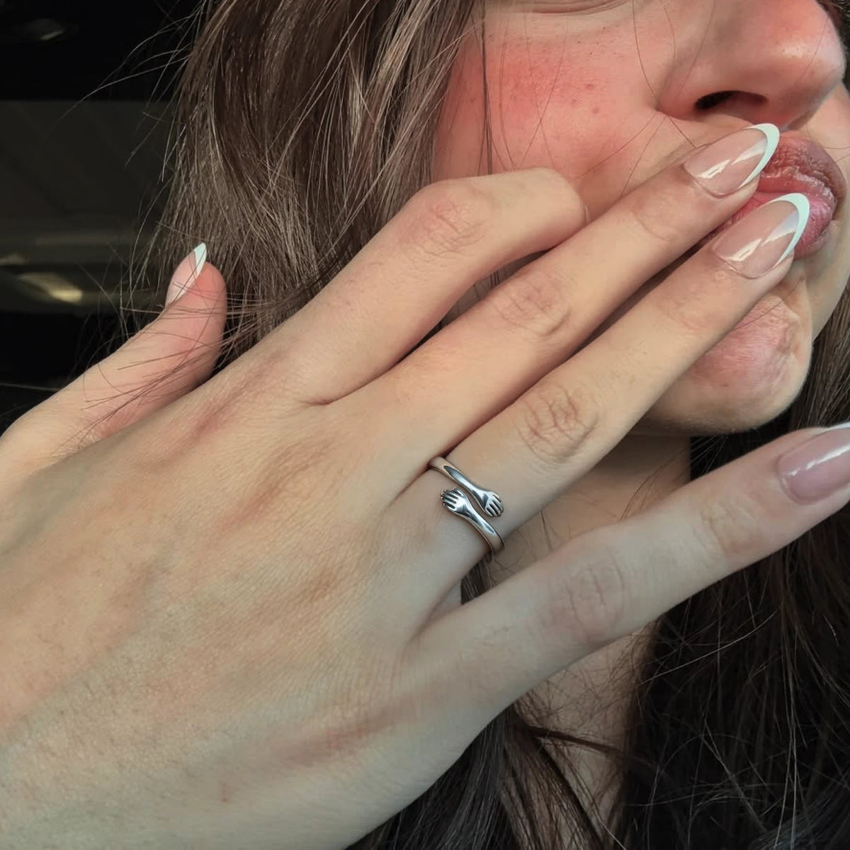 Huggi hug ring on her hand