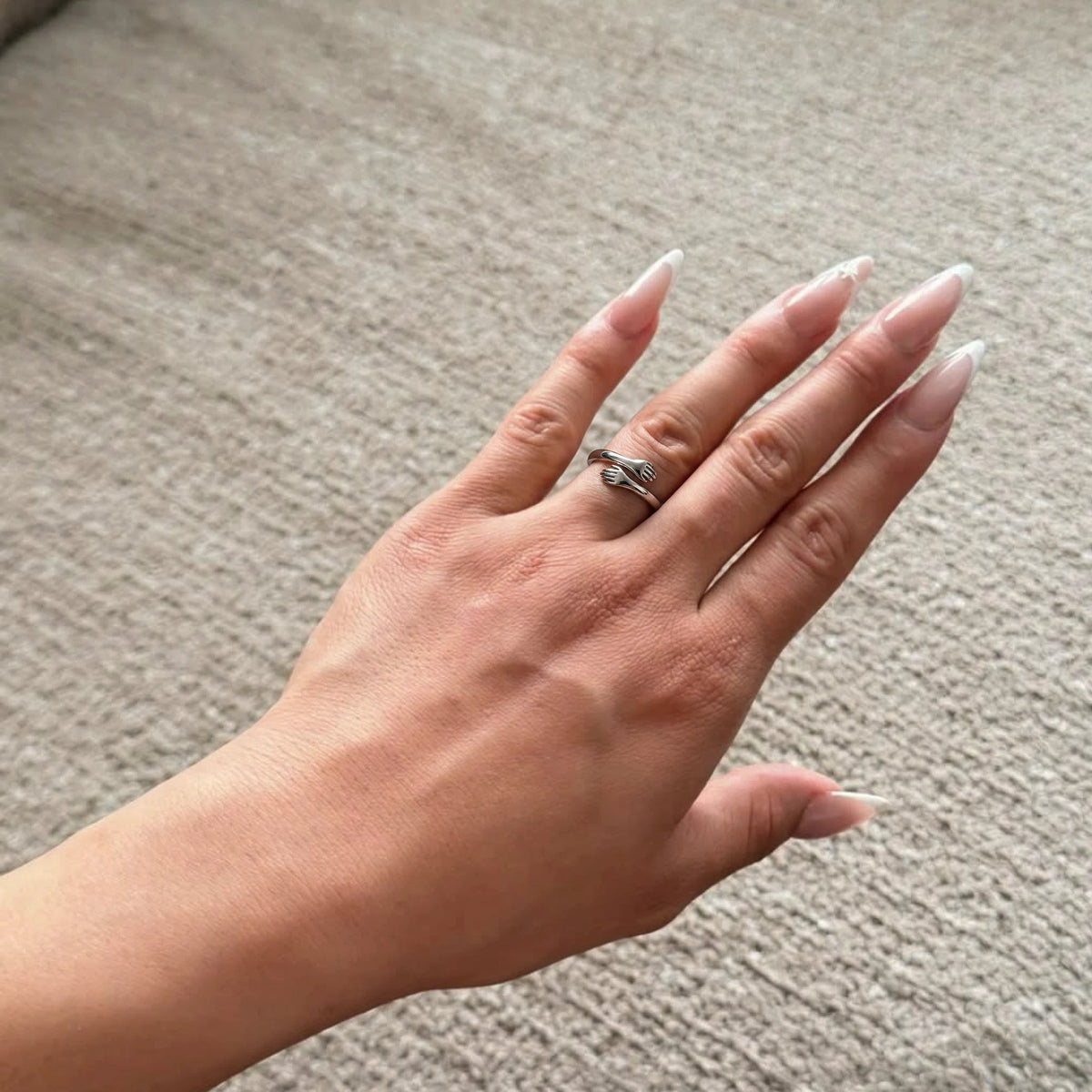 Huggi hug ring on a relaxed hand
