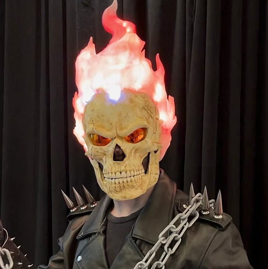 Inferno Reaper mask worn with a spiked leather jacket and chains