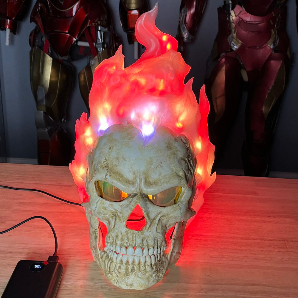 Inferno Reaper mask on a table with the red flames turned on