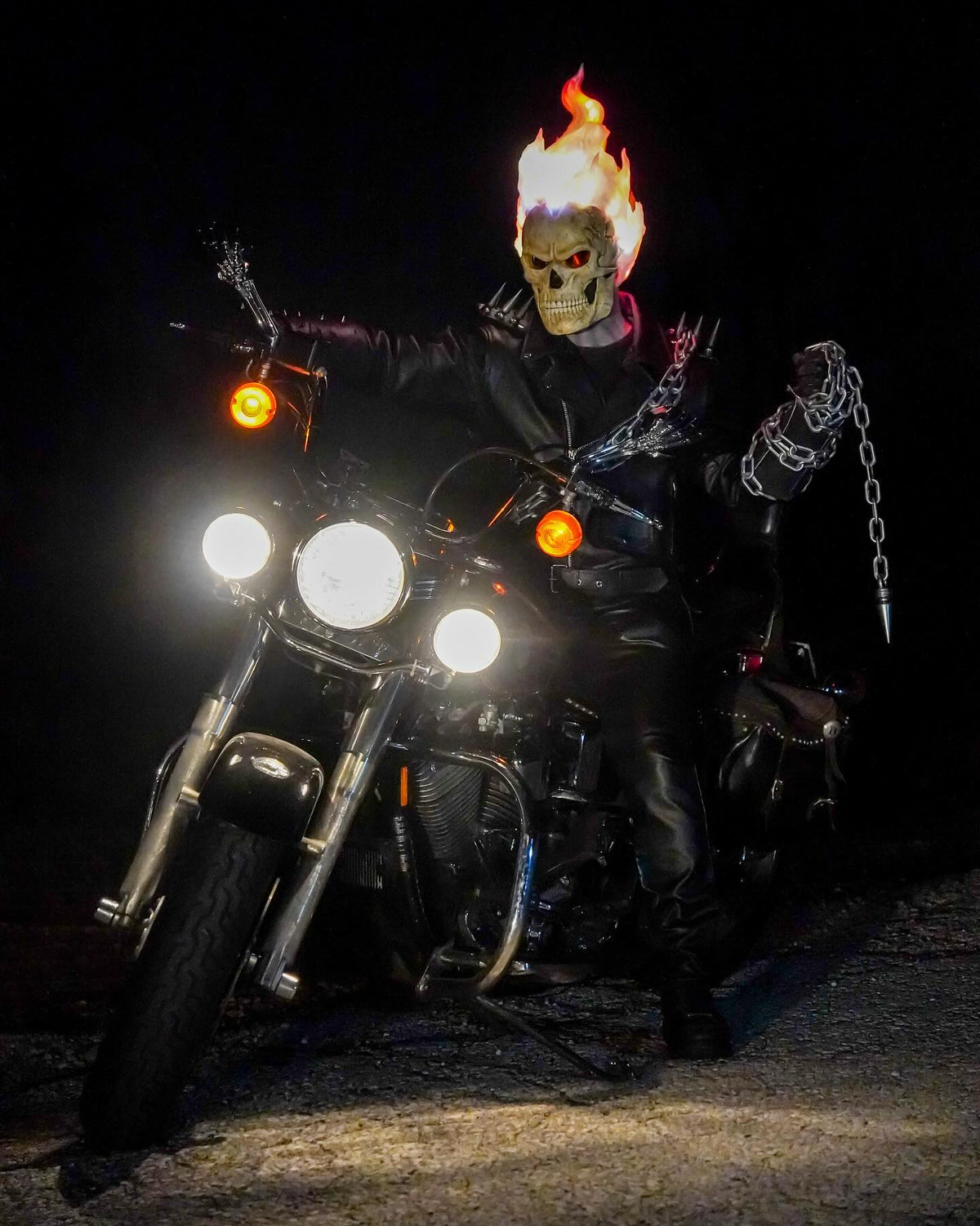 Rider wearing the Inferno Reaper mask on a motorcycle at night