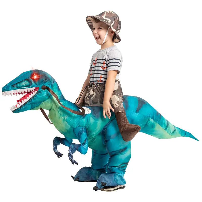 Child riding a blue Raptie ride-on dinosaur costume